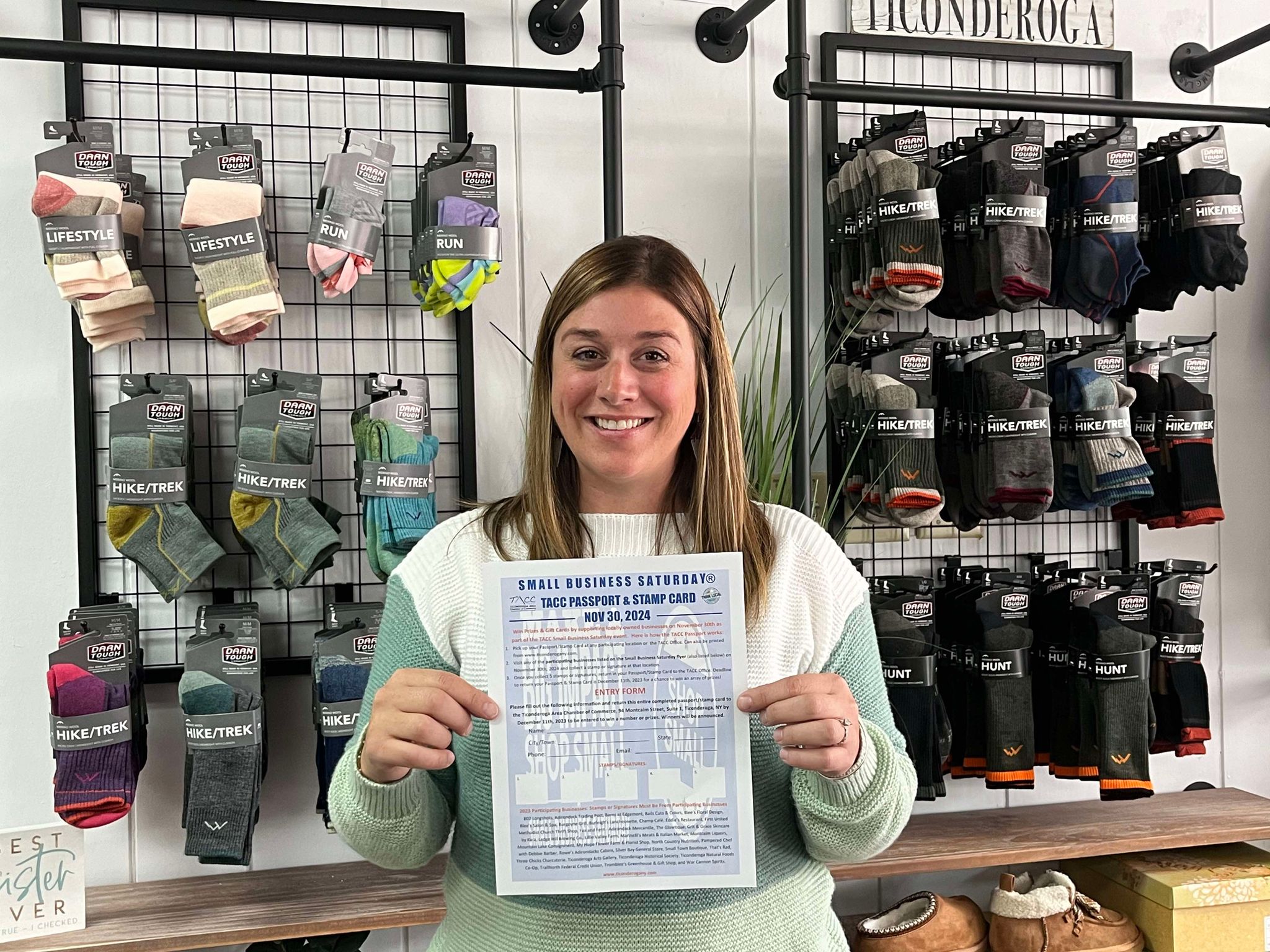A store owner in front of a sock display