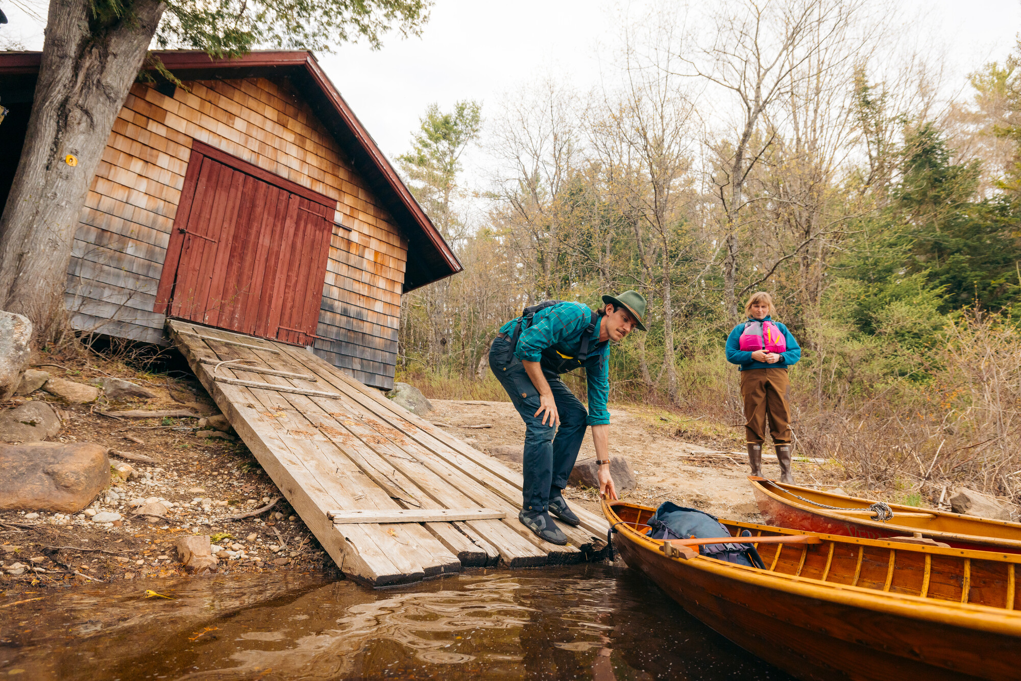 Two pack canoes being put in the water