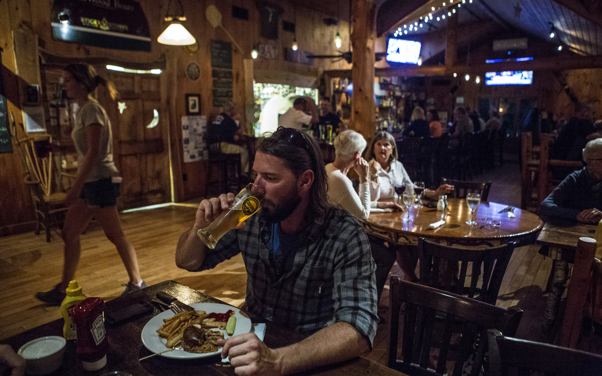 The interior of a relaxed, rustic bistro with wood trim and a tavern feel.