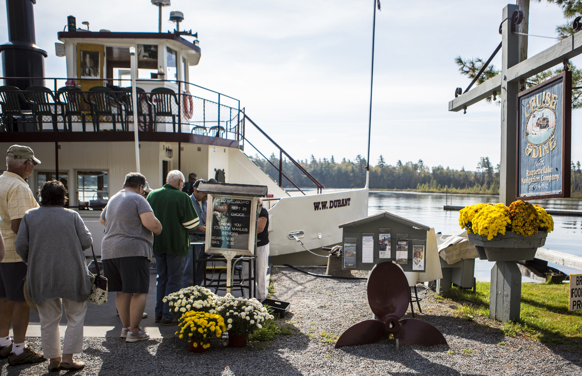 People in line waiting to board a boat