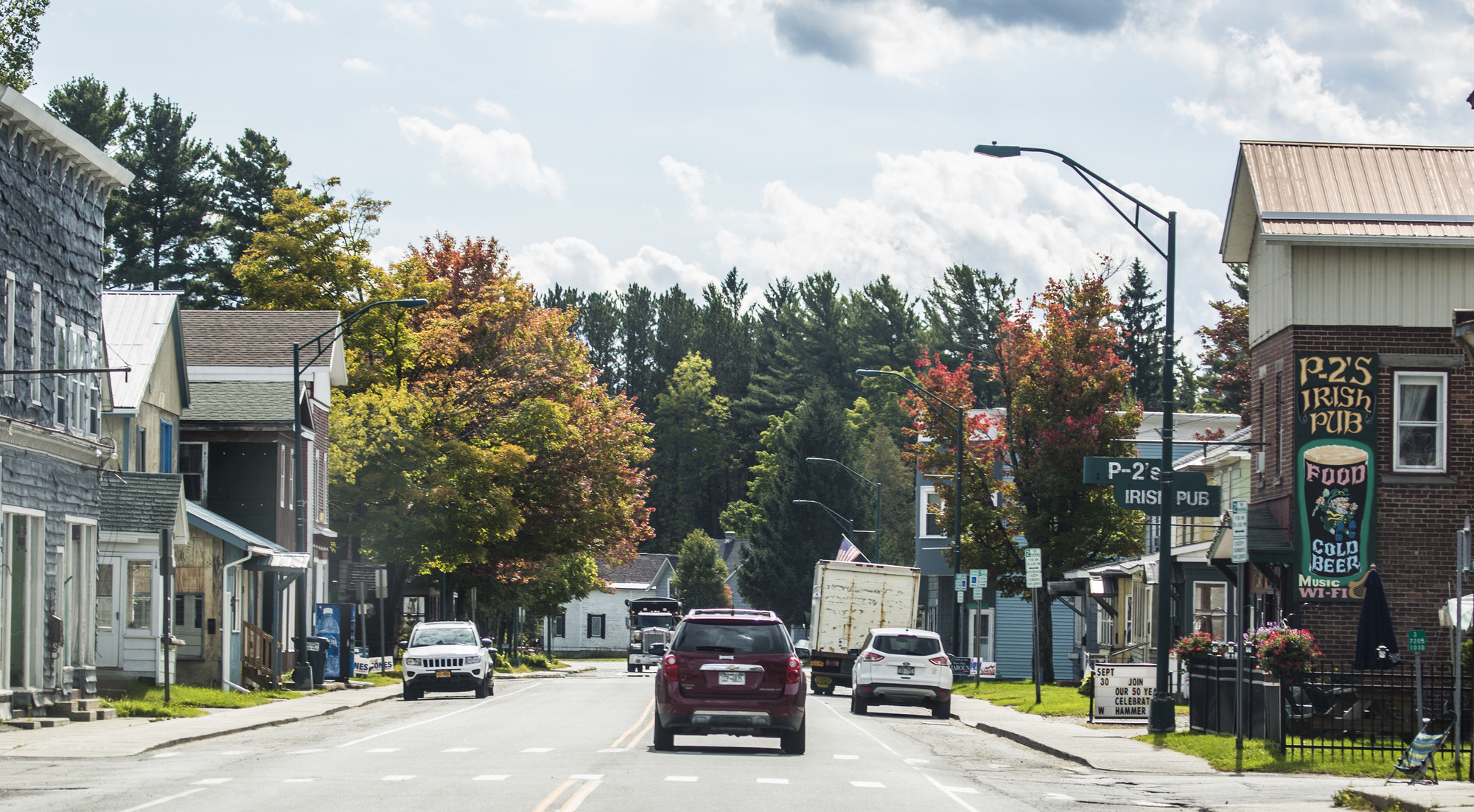 An autumn street scene in Tupper Lake, with P-2's Irish Pub on the right side of the street.