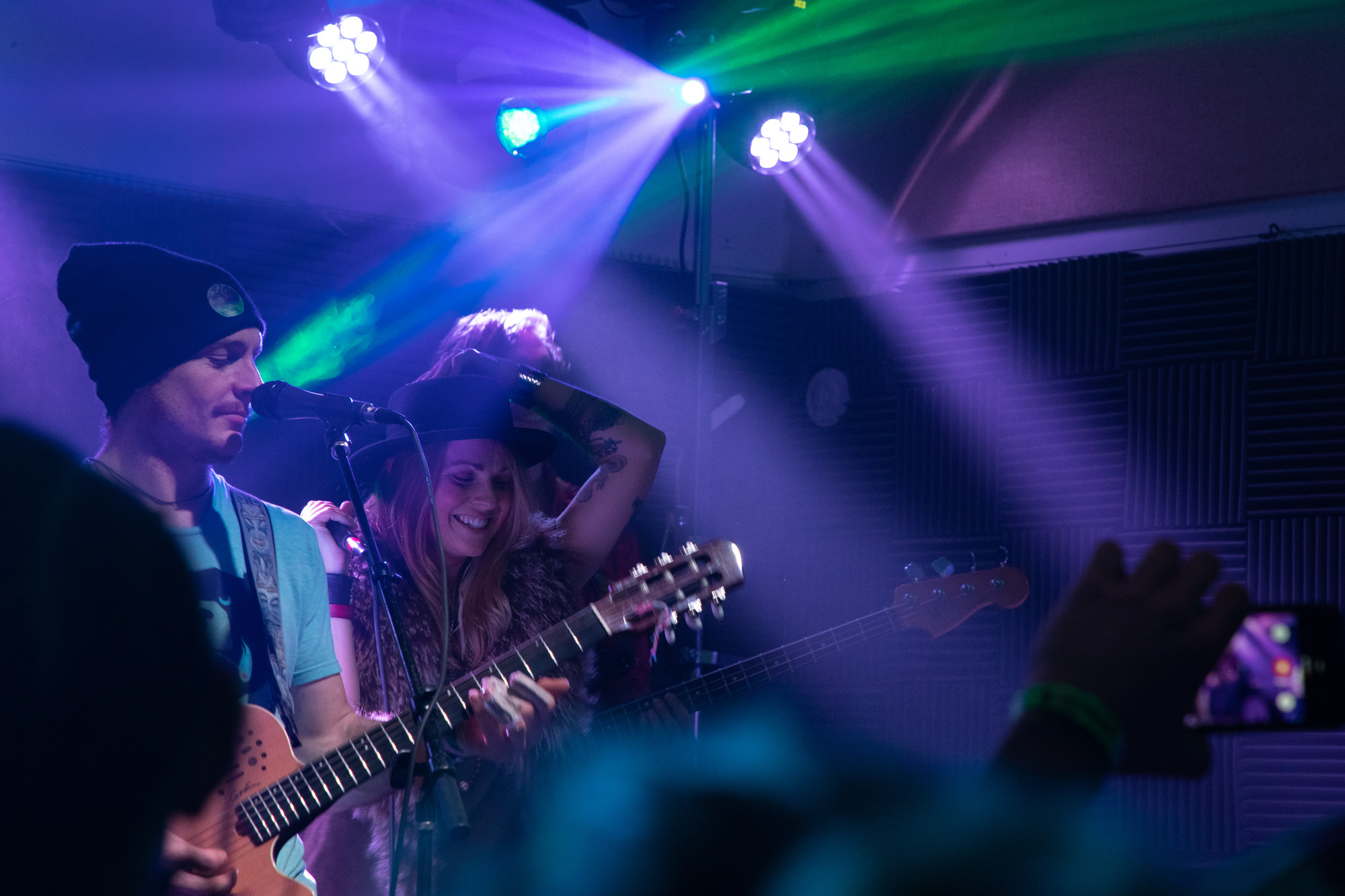A woman and man in a band perform.