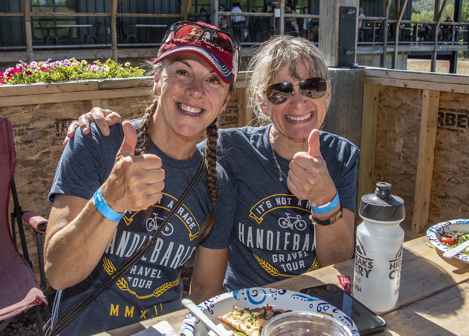 Two women enjoying beers at Paradox Brewery after a ride. 