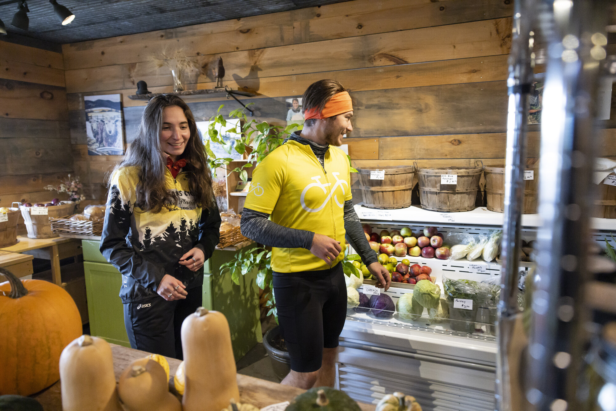  A man and woman shop around a farm store.