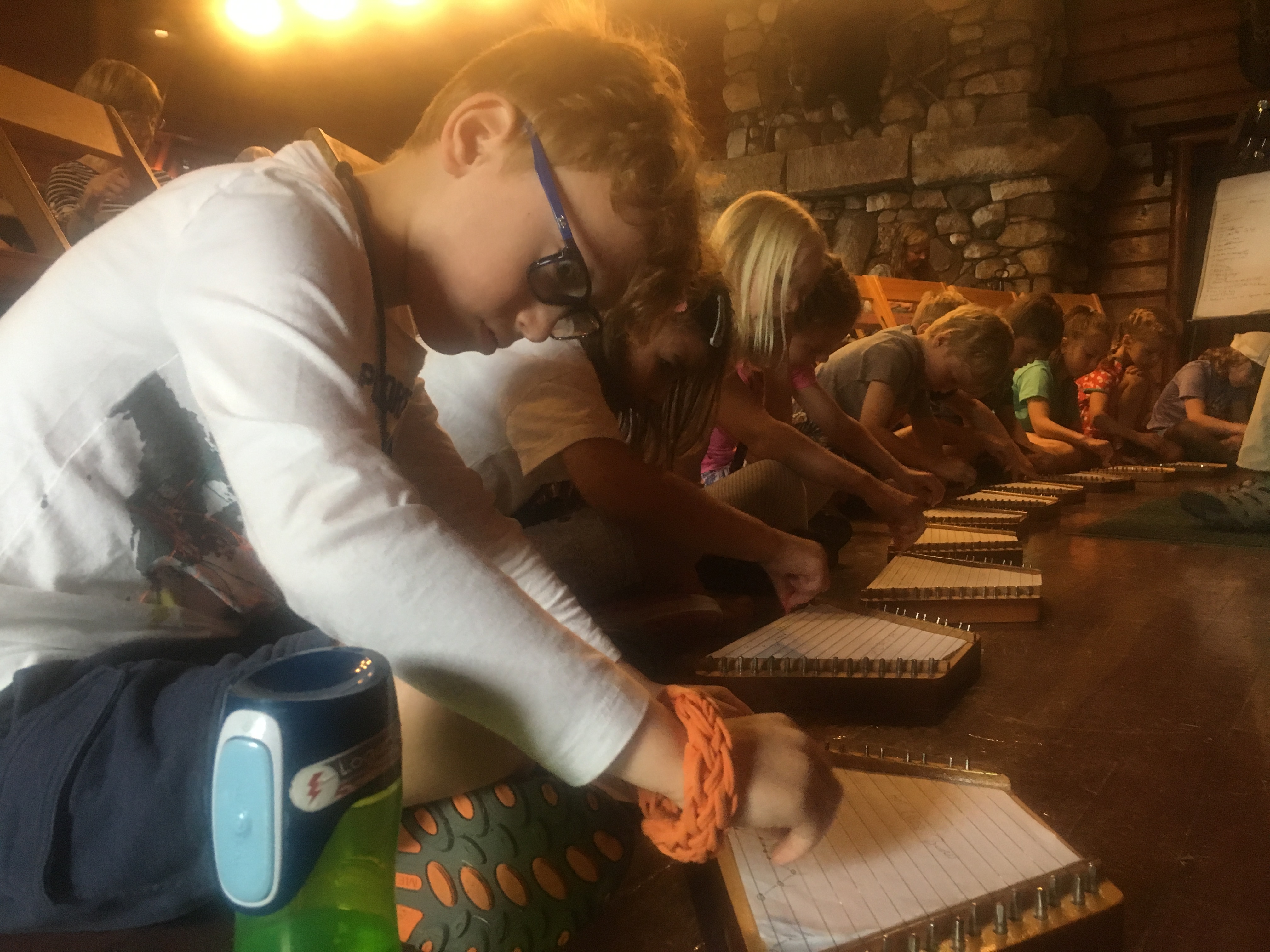 Kids practicing their table harps with Dan Duggan.