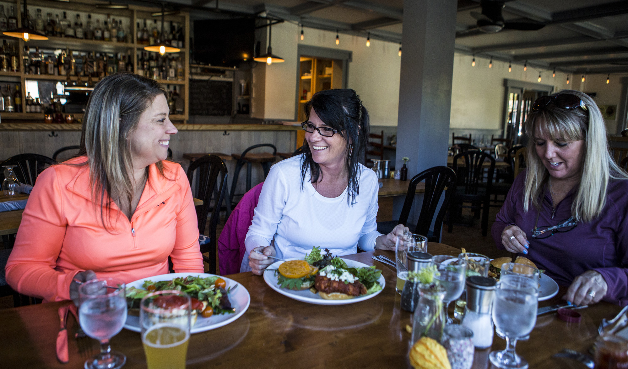 Three woman smiling and eating food at Deer's Head Inn