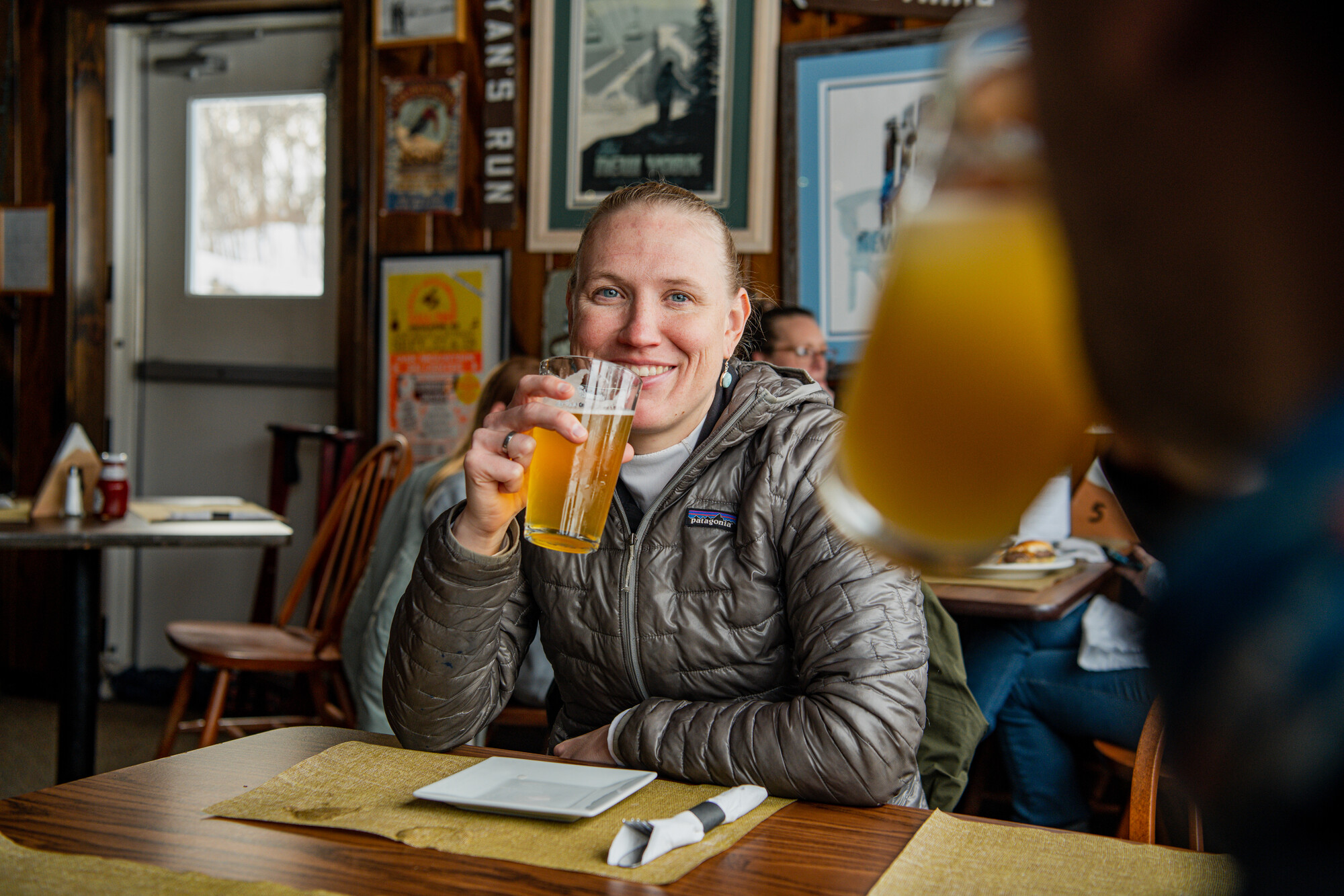 A woman shares a drink at a restaurant. 