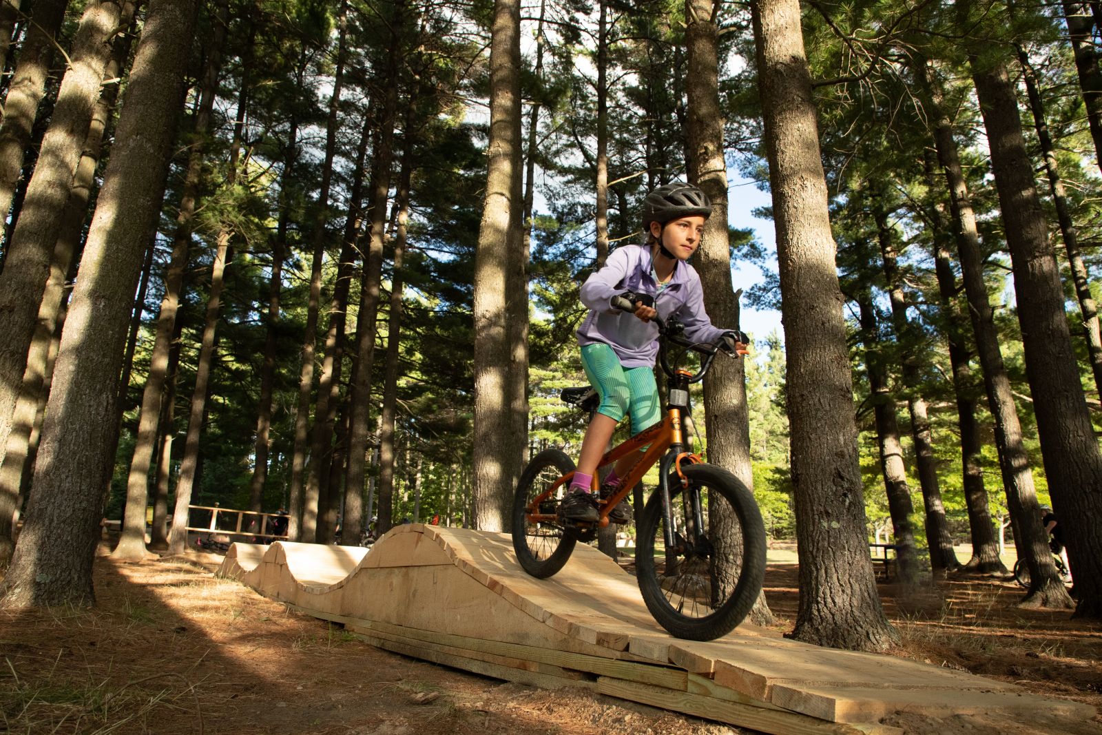 kid riding on wooden ramp