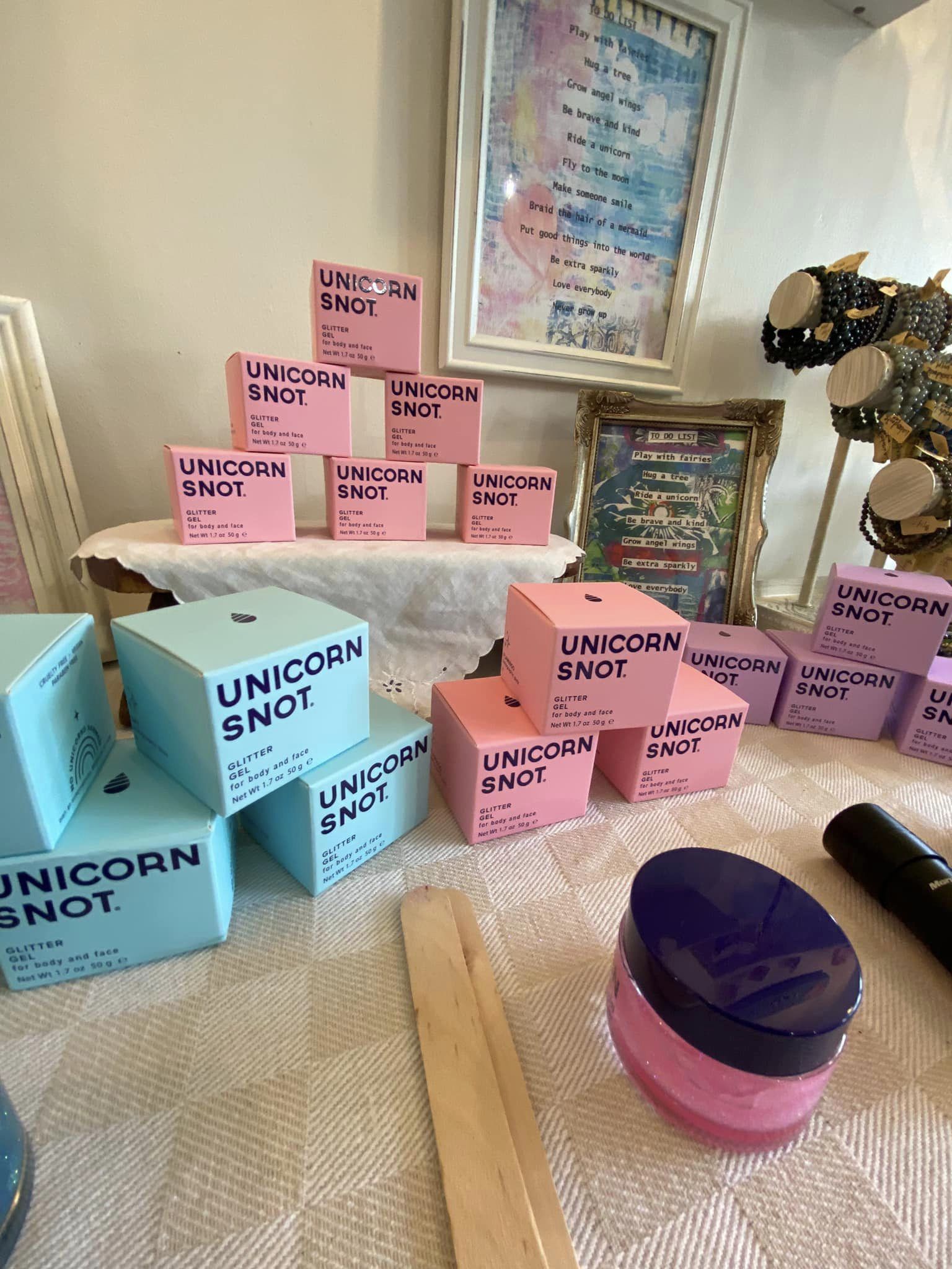 A collection of unicorn themed gifts on a table. 