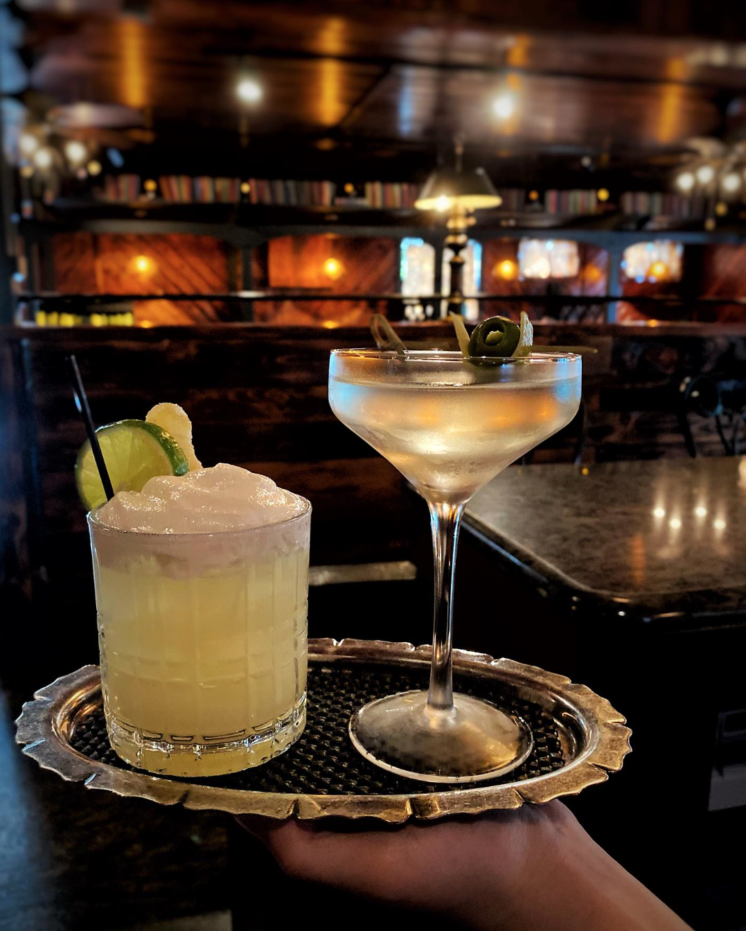 cocktails served in antique glassware and served on vintage metal tray