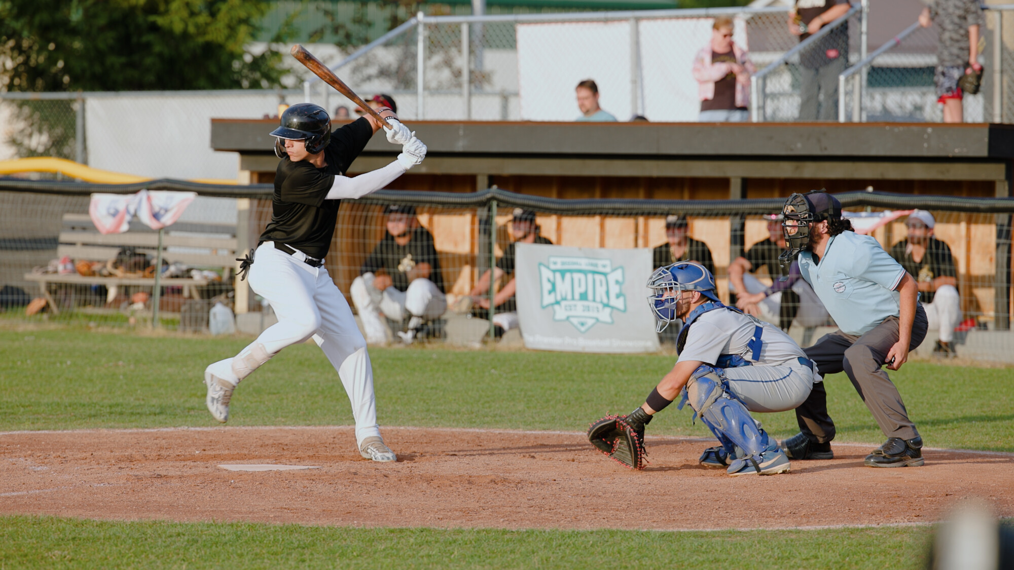 A Riverpigs baseball player swings at the ball.