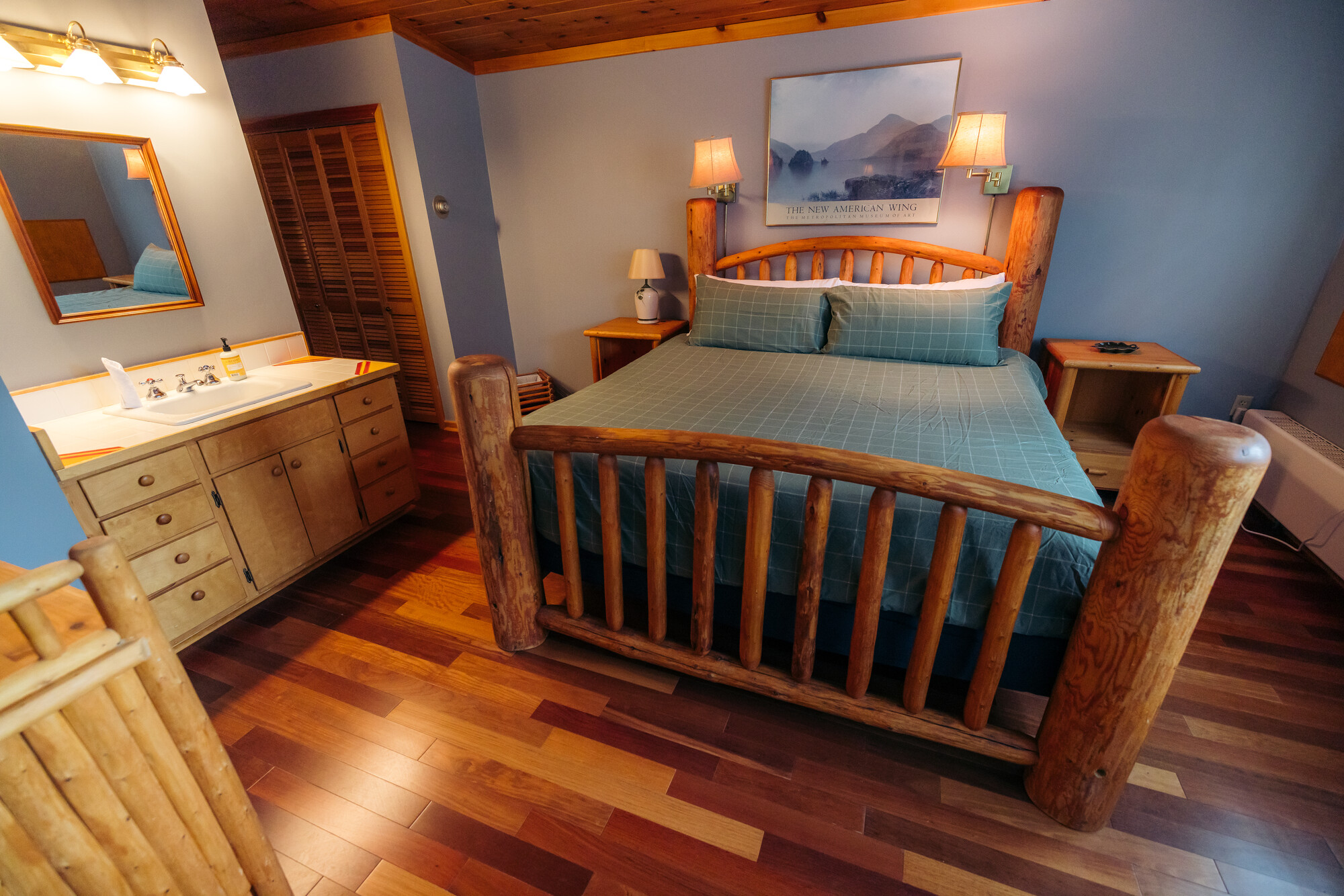 A lodge style hotel room with blue accents.