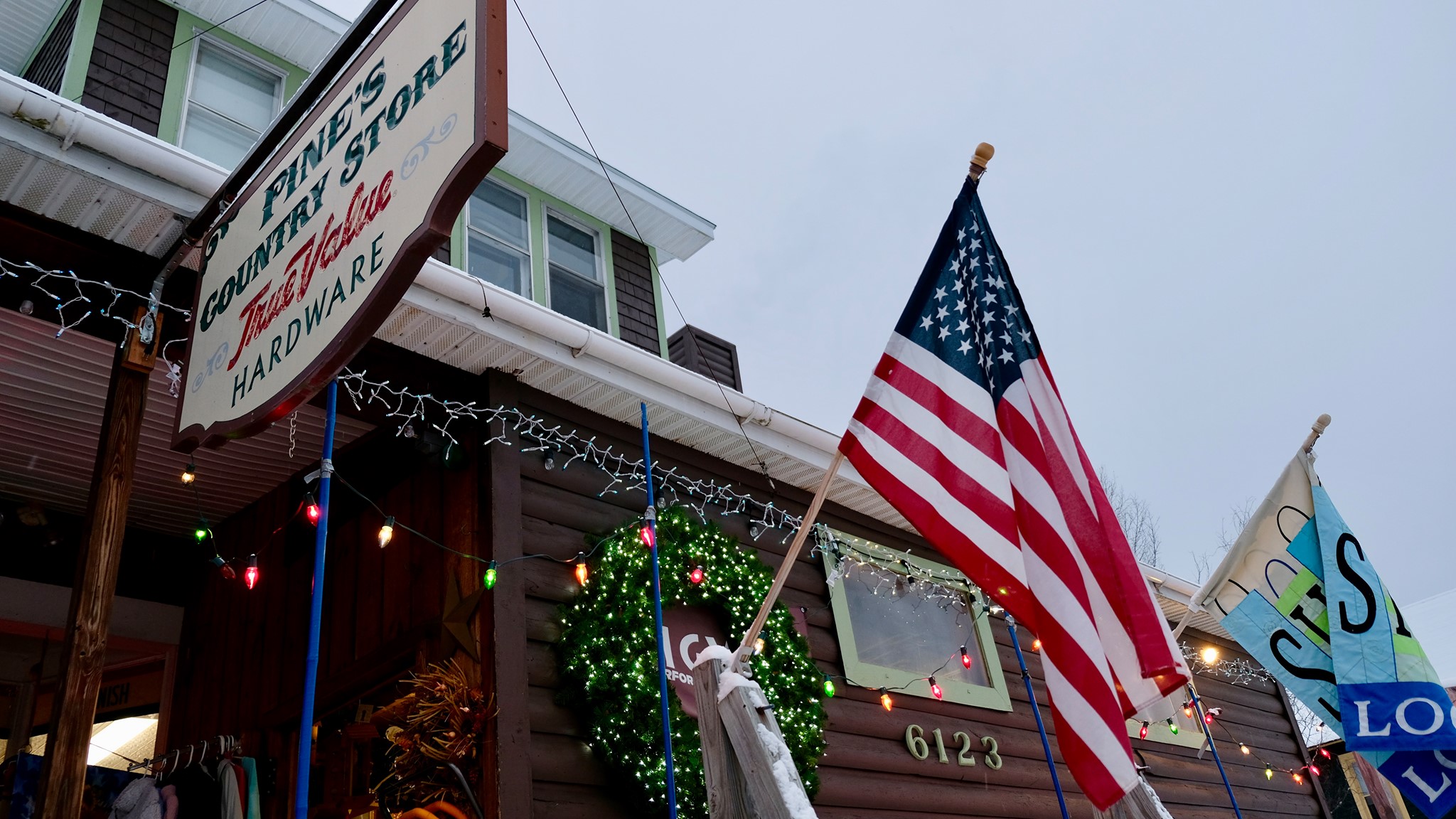 Pine's Country Store sign and American flag