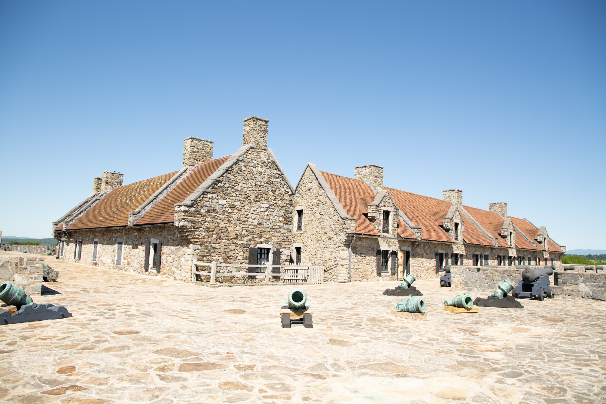 Historical building at Fort Ticonderoga featuring canons and stone wall structures