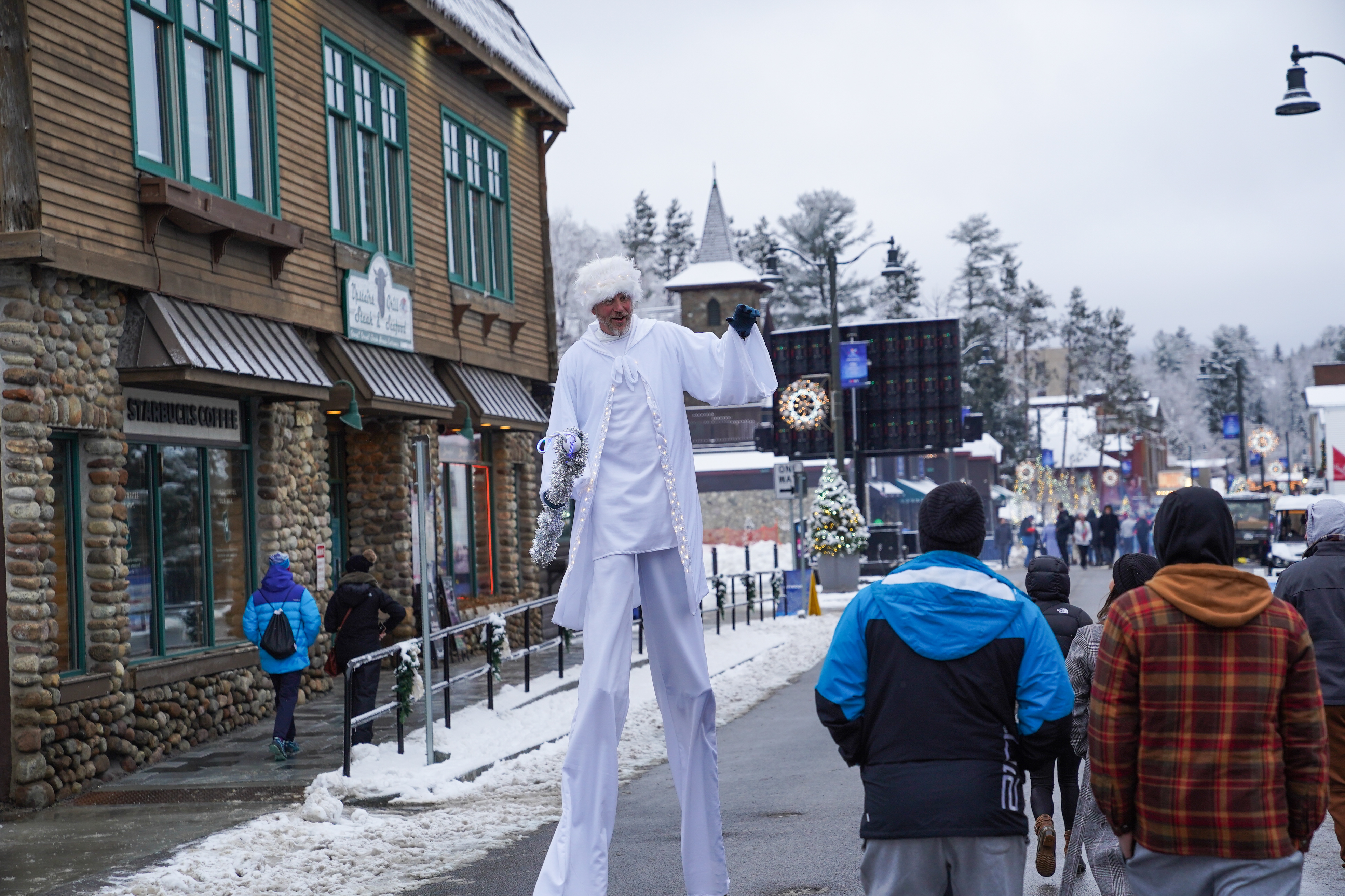 Stilt Walkers stroll through Main Street during the Lake Placid 2023 FISU Game Festival 