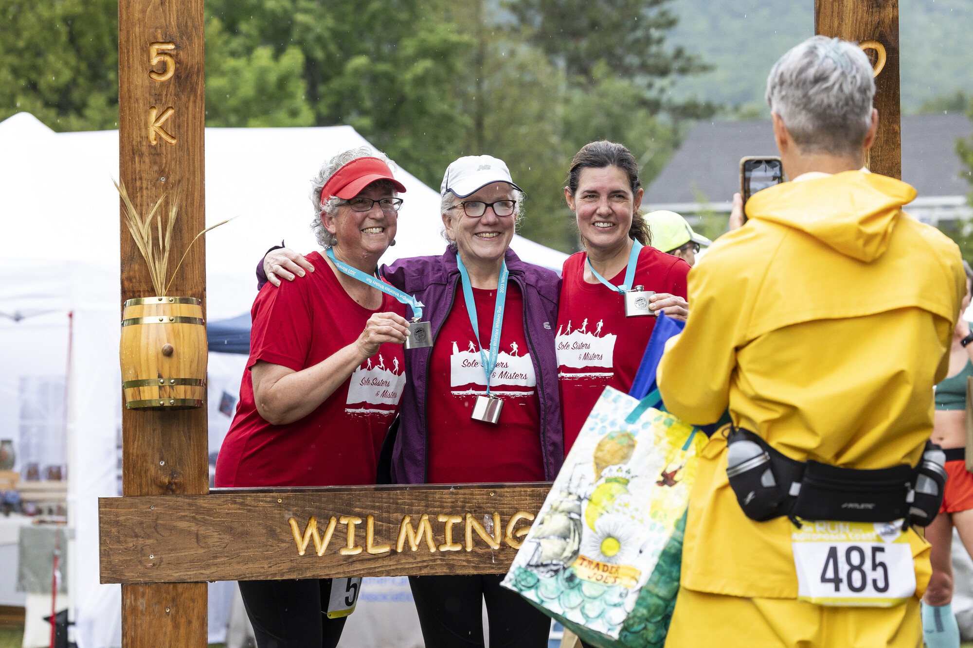 Three older women take a photo for the Wilmington Whiskey Run.
