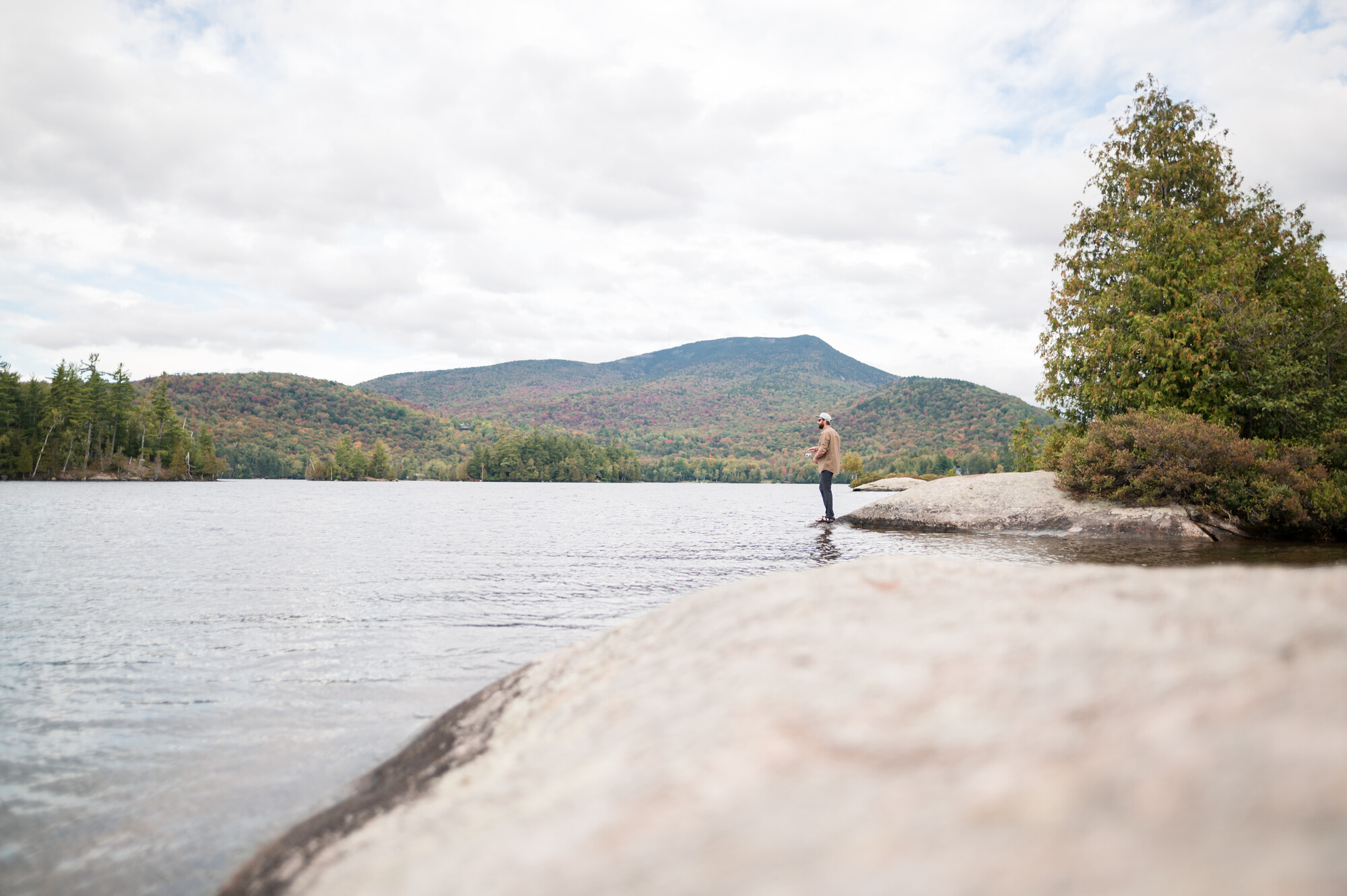 a man fishes off shore.
