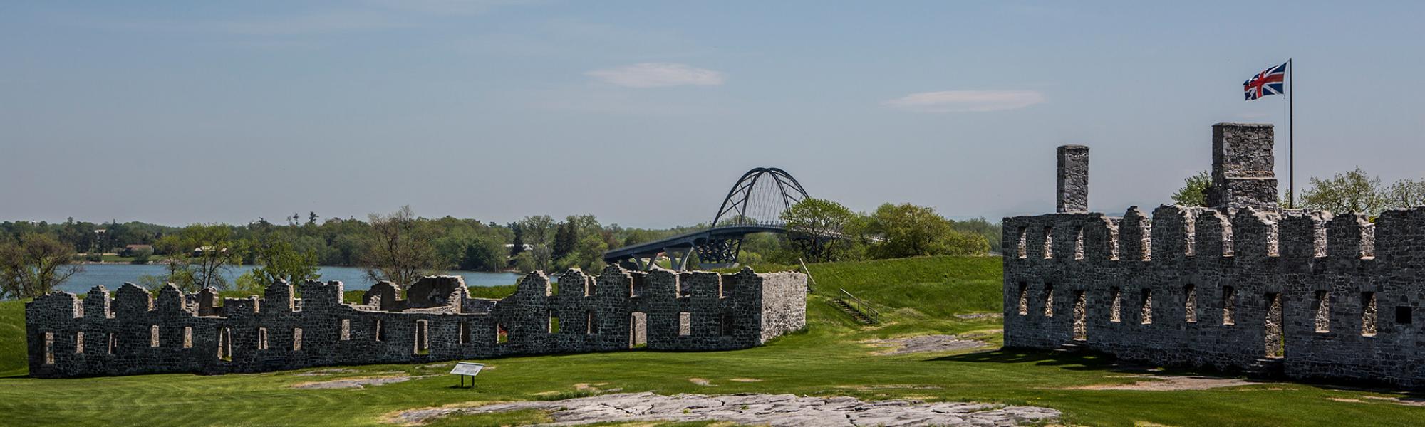 A panorama of the ruins of Crown Point fort with the Champlain Bridge in the background.